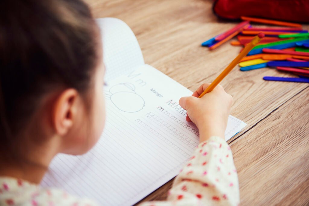 Pediatric Occupational Therapy About Oaknine Healthcare: child working on handwriting with occupational therapist at home