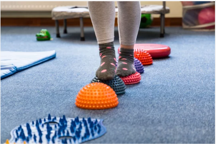 Child Balancing in Physiotherapy Child practicing balance and coordination in Physiotherapy
