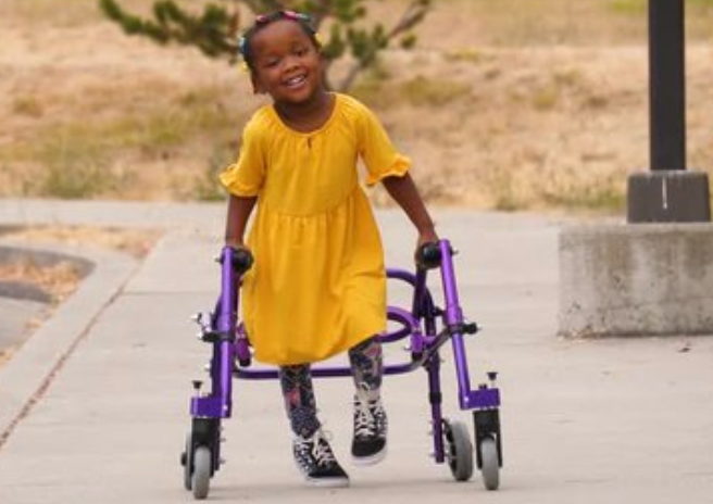 Child with Cerebral Palsy Walking with Walking Aid Child with Cerebral Palsy Walking with Walking Aid