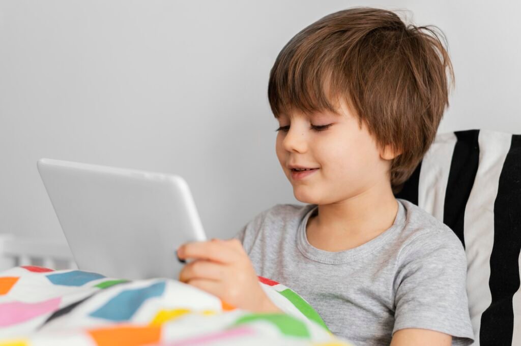 kid using speech device kid using AAC device to communicate