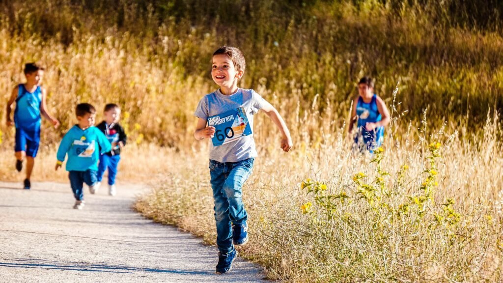 Endurance and Stamina Children joyfully running in a park during a cheerful outdoor race event.